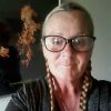 Woman with glasses and braids at Reigning Downs Hauora Centre.