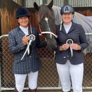 Two women in riding gear with a horse at Reigning Downs Hauora Centre.