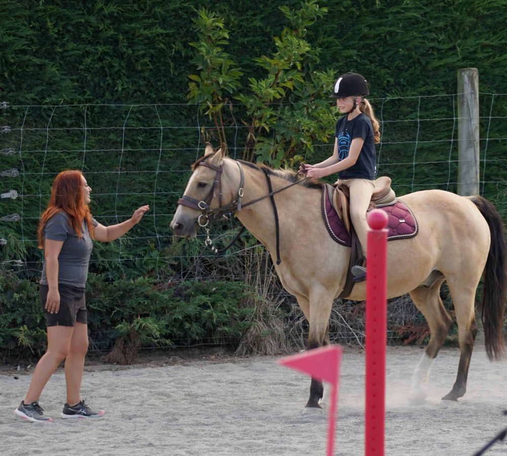 Young girl riding a horse during equine therapy at Reigning Downs Hauora Centre.
