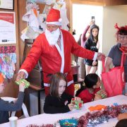Santa Claus giving gifts to children at Reigning Downs Hauora Centre.