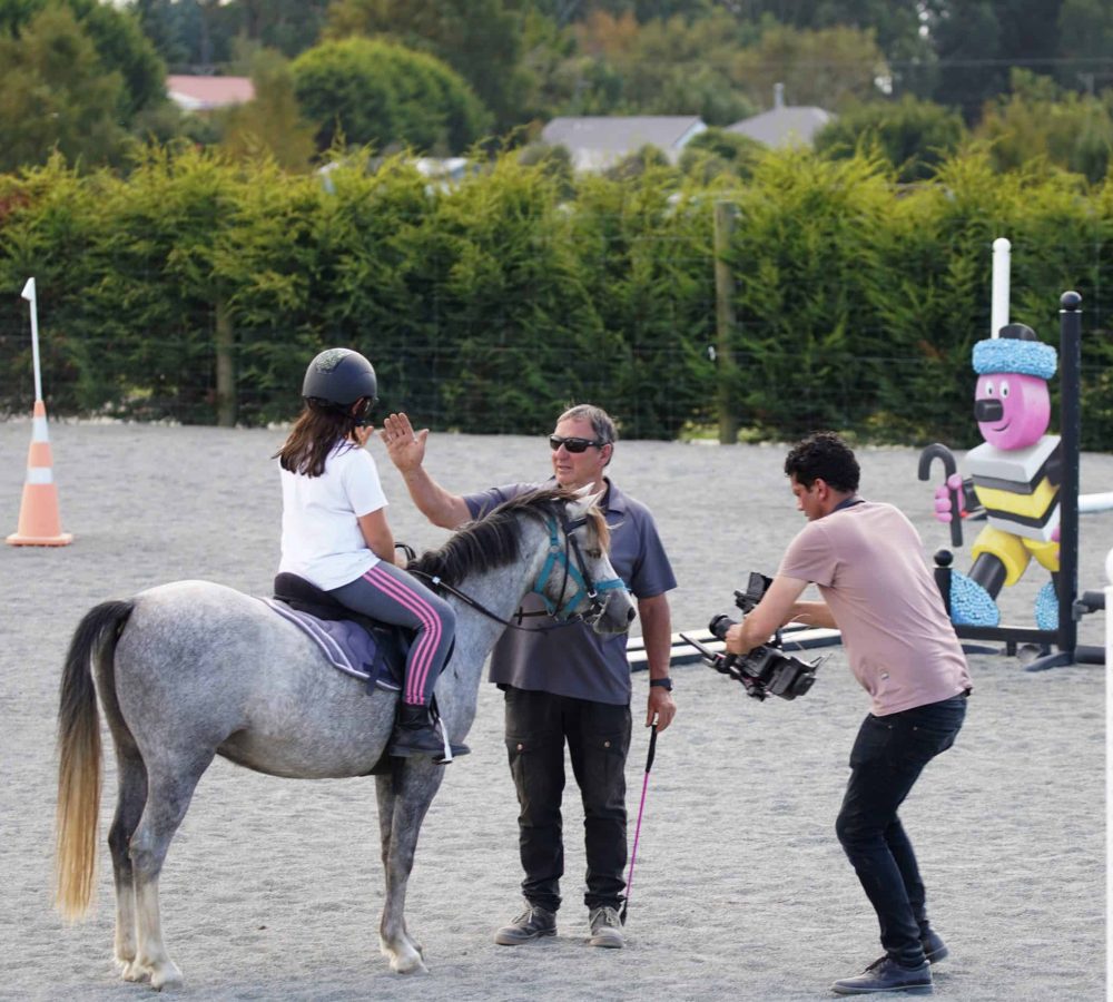 Child riding a horse at Reigning Downs Hauora Centre in New Zealand.
